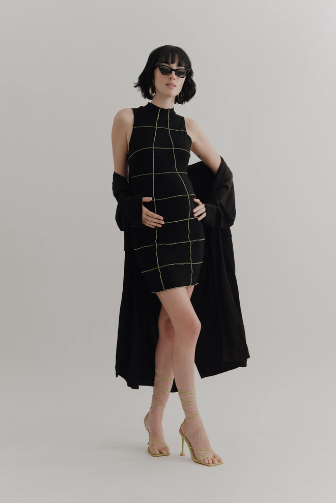 fashionable maternity store offers bold styles with this black baby shower dress